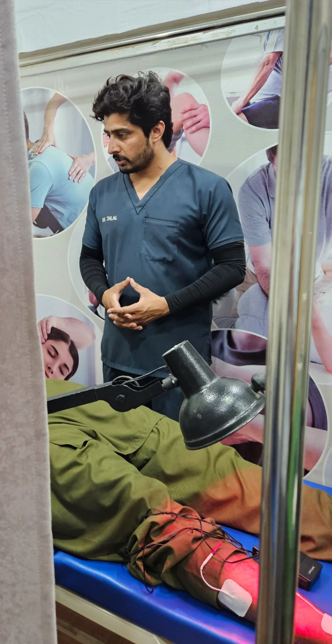 PainFix physiotherapist Dr. Jalal assisting a patient during a treatment session at the clinic.